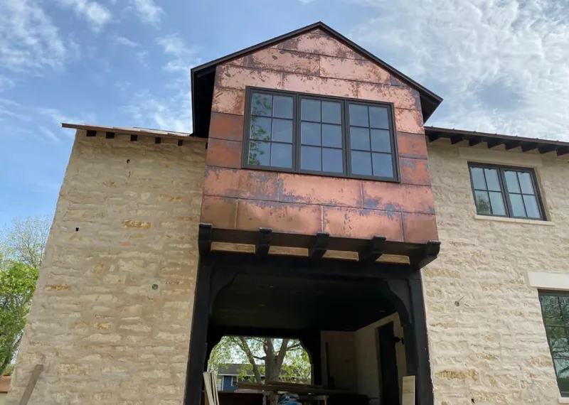 Copper metal panel facade on a stone building for Skylight Installation in Warren